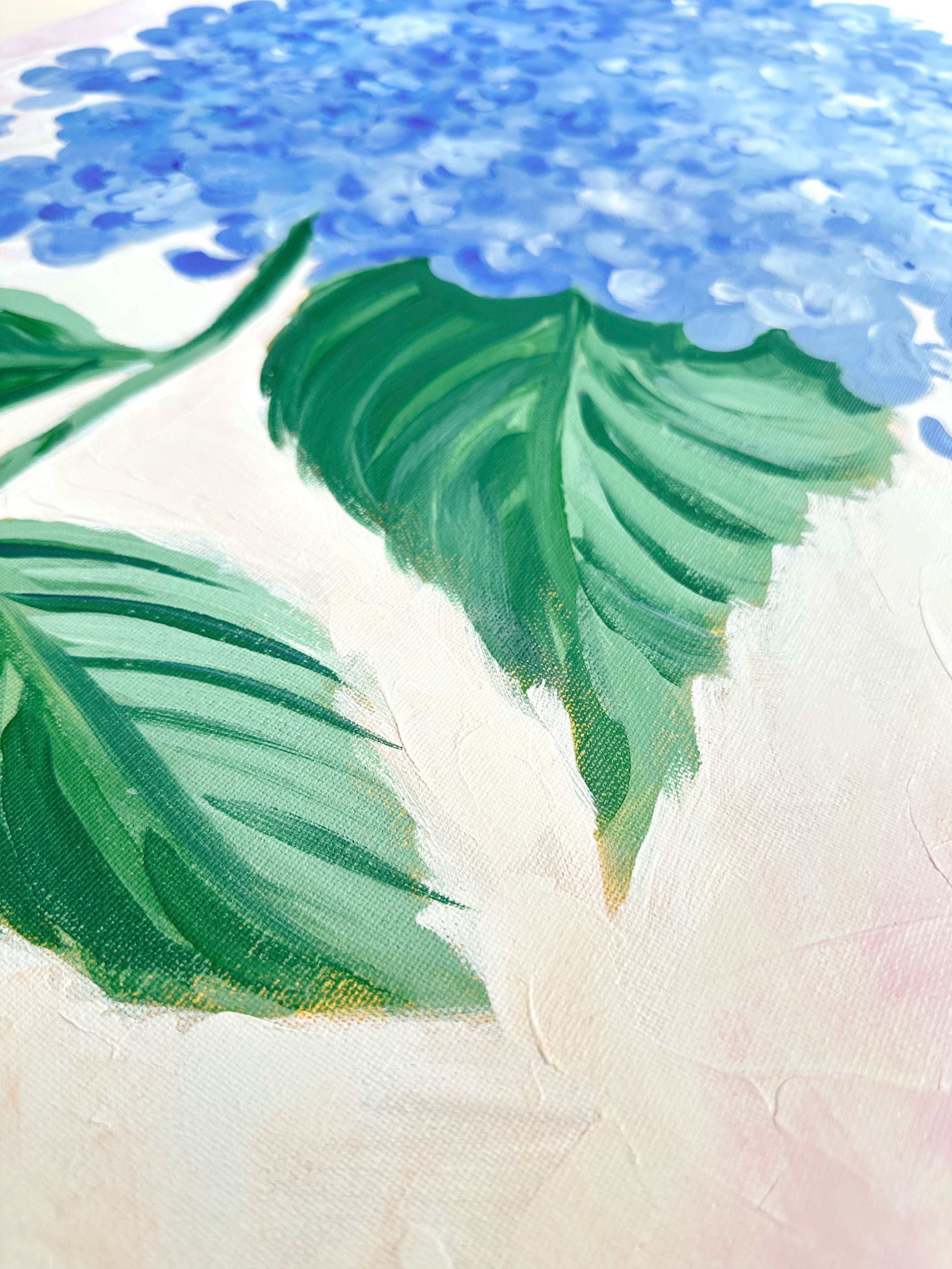 Large canvas painting of a blue hydrangea flower with green leaves on a light background, 24" x 30"